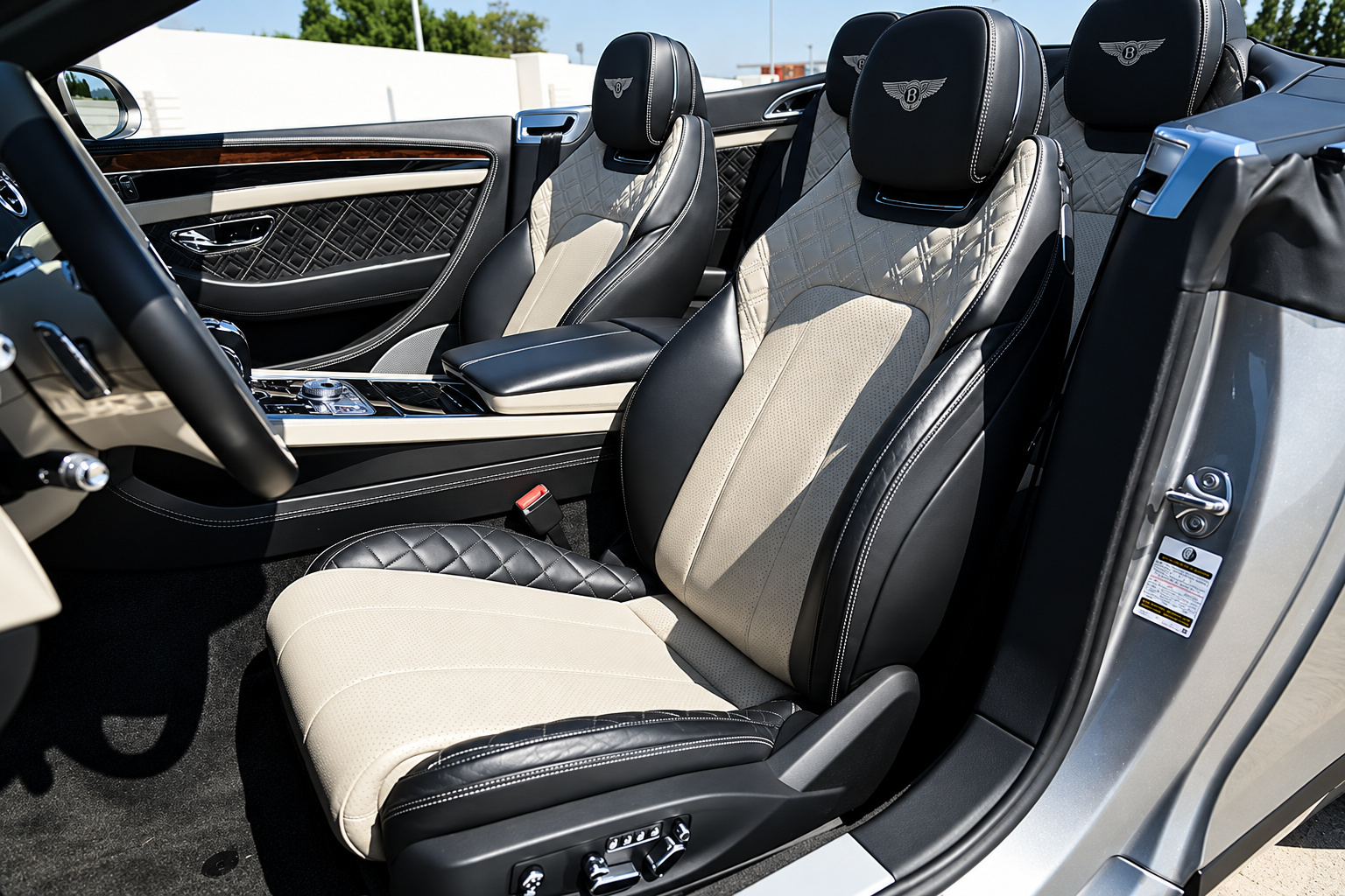 Black and ivory diamond-quilted front seats of the Bentley GTC First Edition seen through the open door