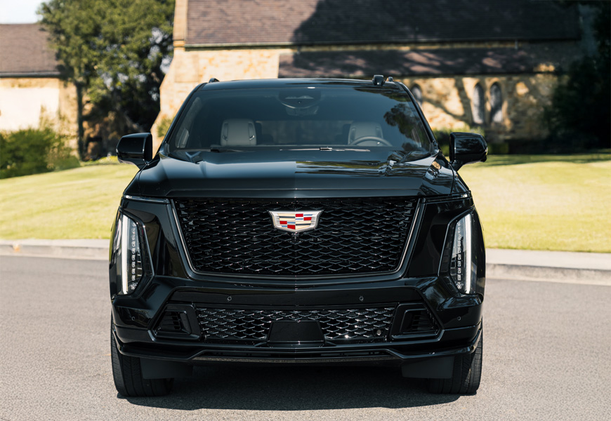 Head-on view of the black Escalade-V, vertical headlamps and the V mesh grille with the Cadillac crest