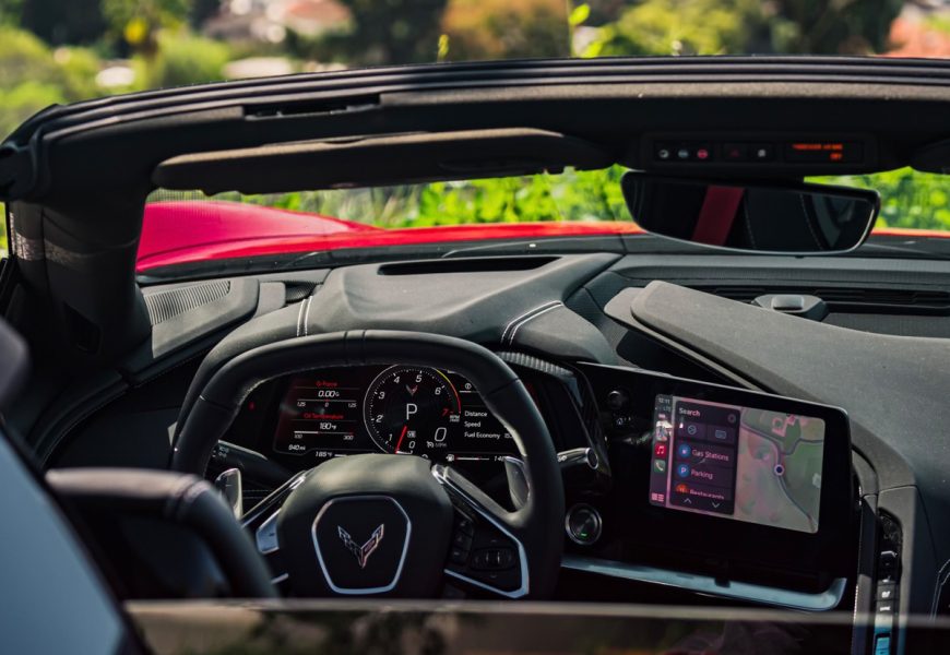 Corvette C8 Stingray cockpit through the open roof, square steering wheel, digital cluster and centre screen