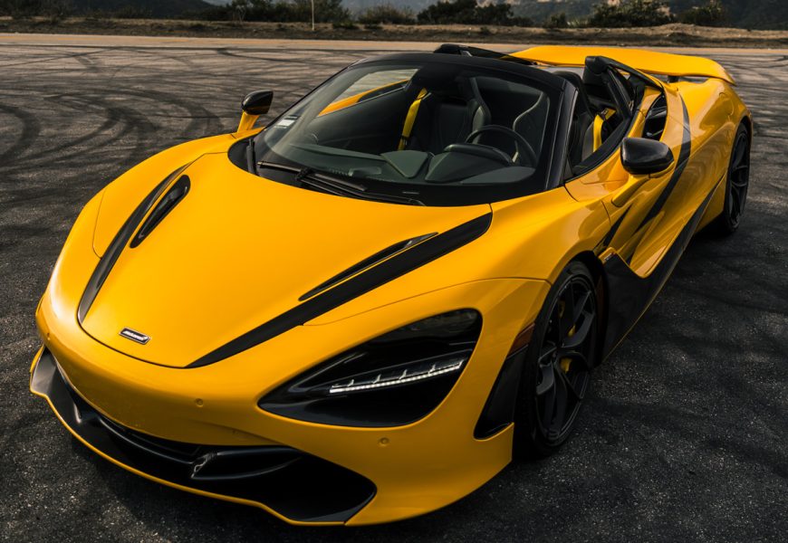 Low front three-quarter of the yellow McLaren 720S Spider MSO, roof down, black wheels and yellow calipers on Angeles Crest