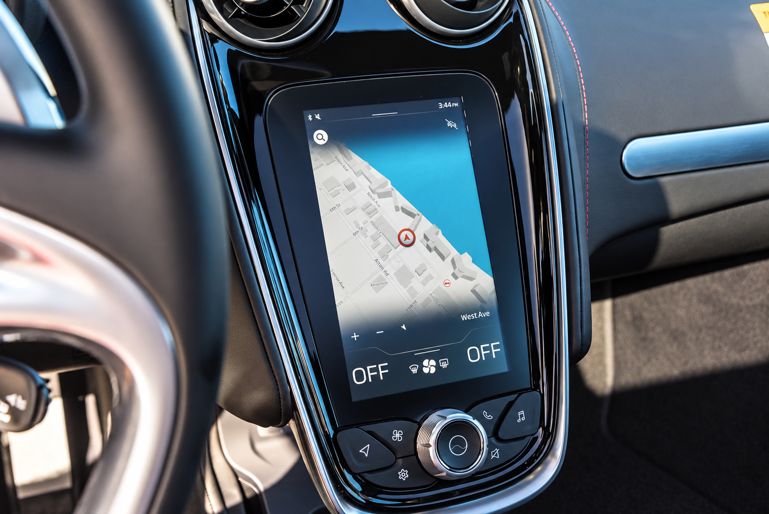 Close view of the portrait IRIS screen and climate dial on the McLaren GT console, red stitching on the trim