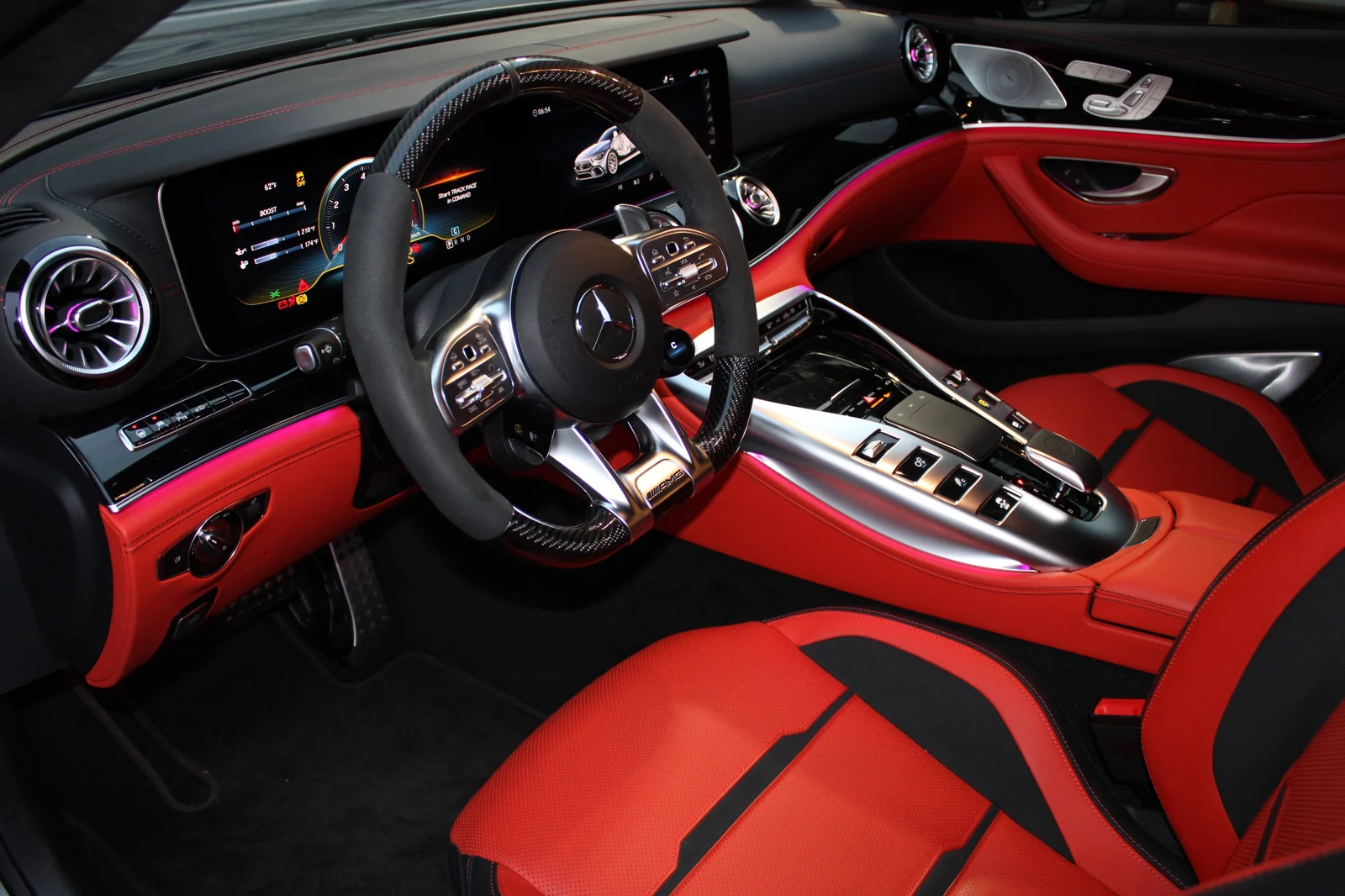 Driver's cockpit of the satin grey AMG GT 63, red and black leather, flat-bottom AMG steering wheel and console switches