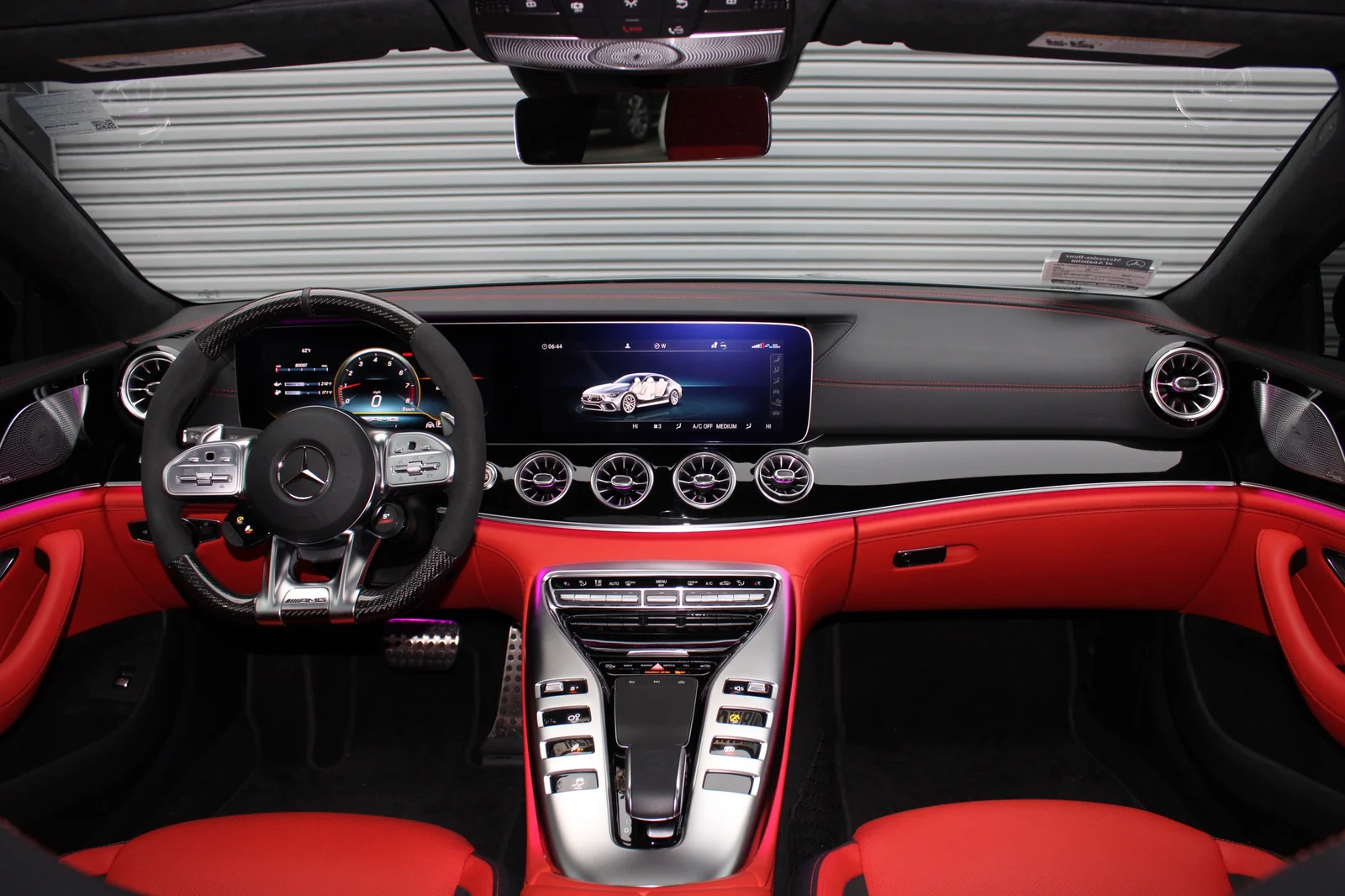 Full dash of the Mercedes-AMG GT 63 from the back seat, twin screens, turbine vents and the red and black cabin