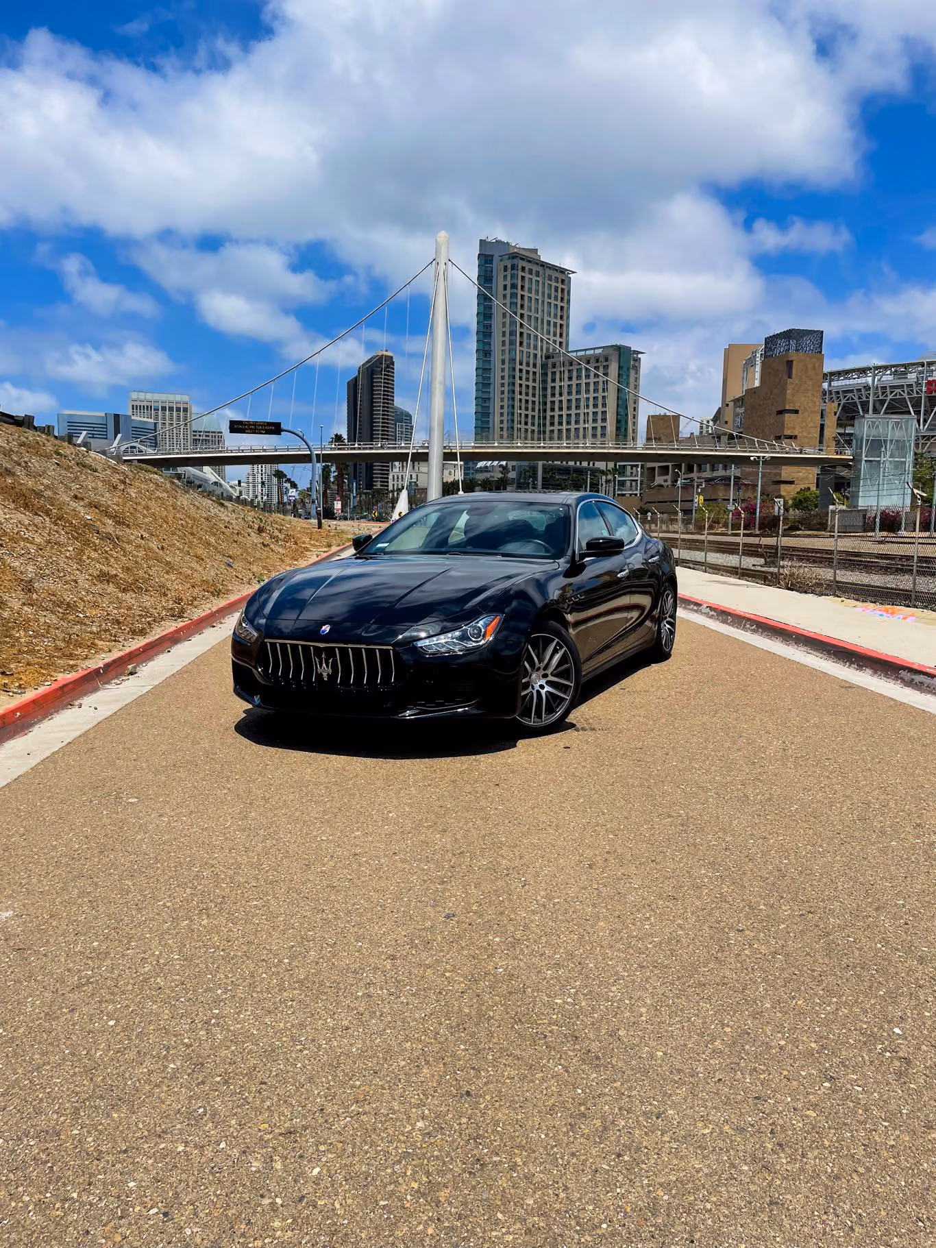 Black Maserati Ghibli, front three-quarter view, a 345 hp twin-turbo V6 sedan to rent in Southern California
