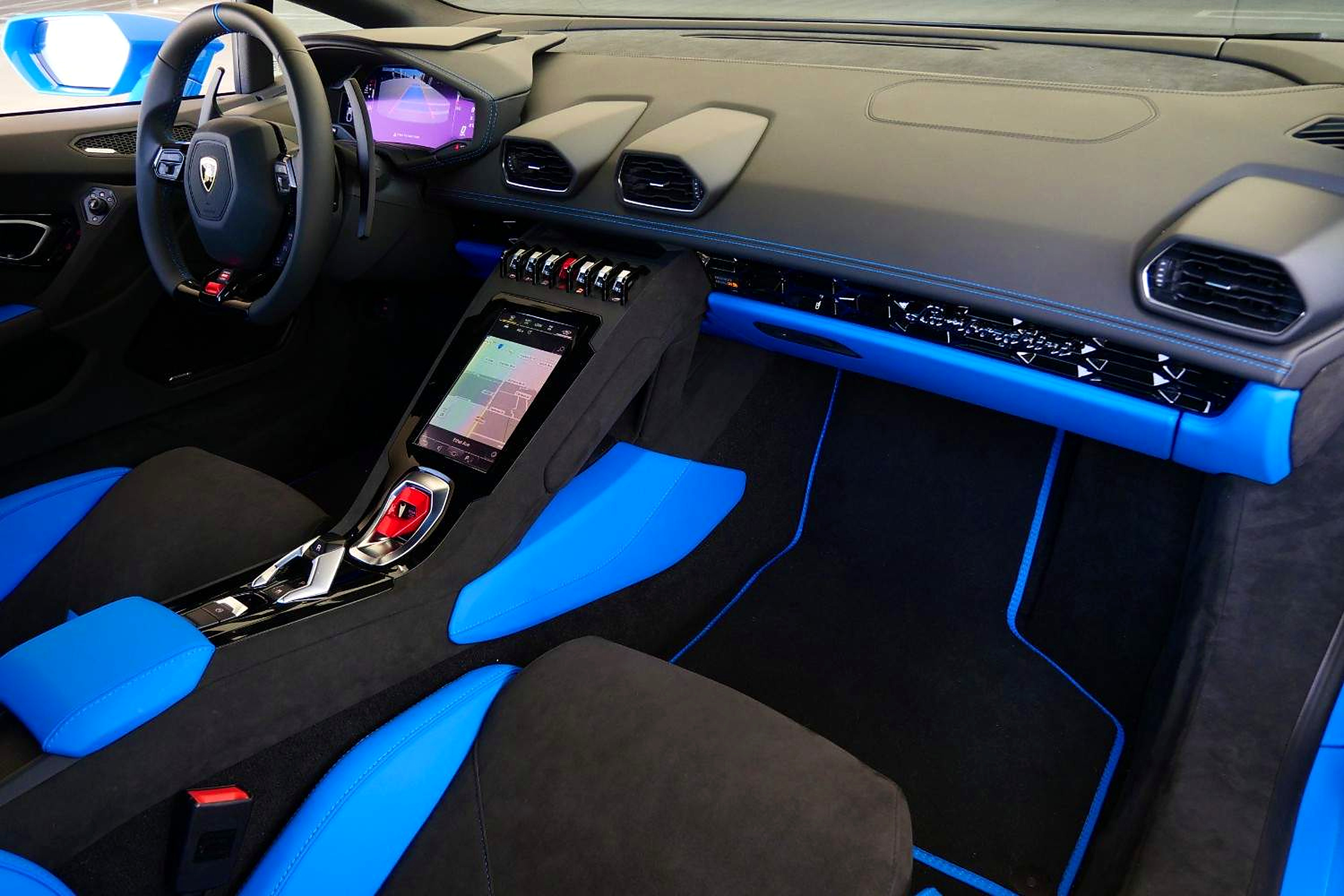 Huracan Tecnica dash with the portrait touchscreen, hexagonal vents and bright blue alcantara inserts