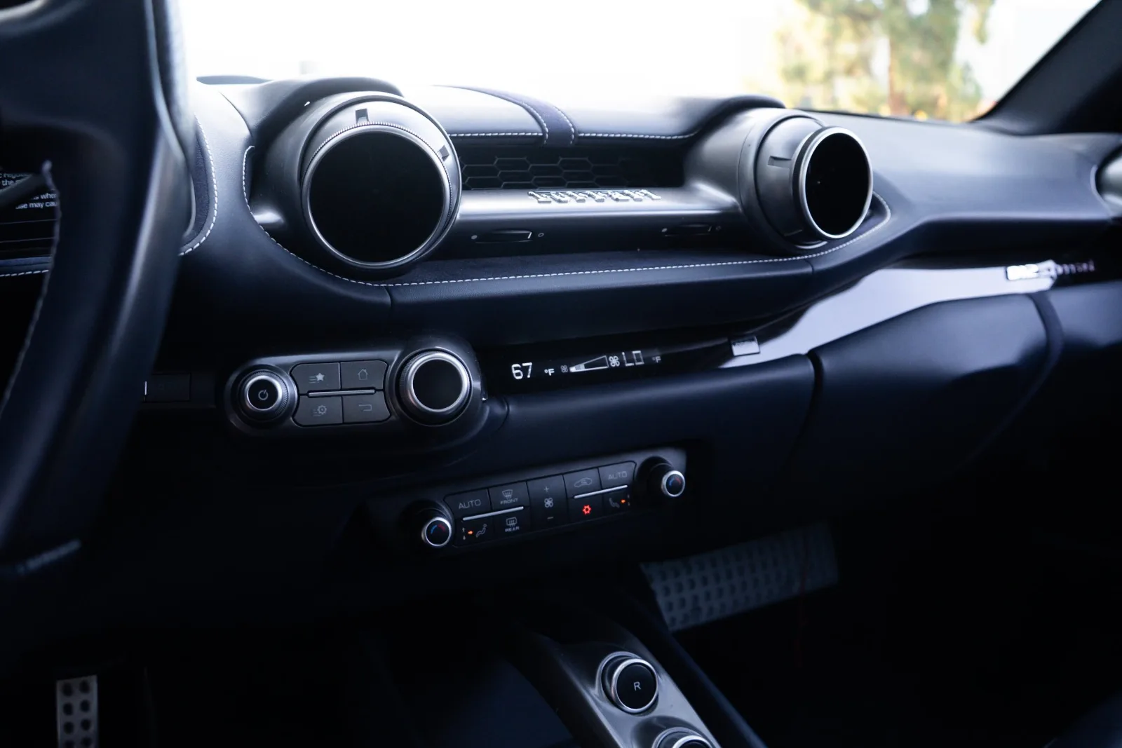 Centre of the 812 Superfast dash with the round air vents and the climate controls in black