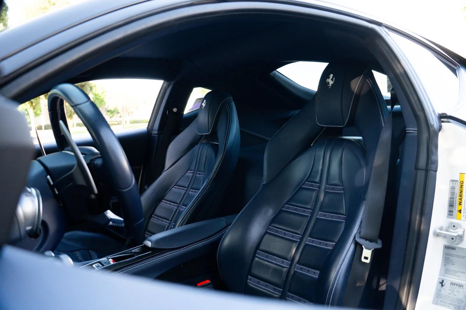 Black leather ribbed seats of the 812 Superfast seen through the open passenger door