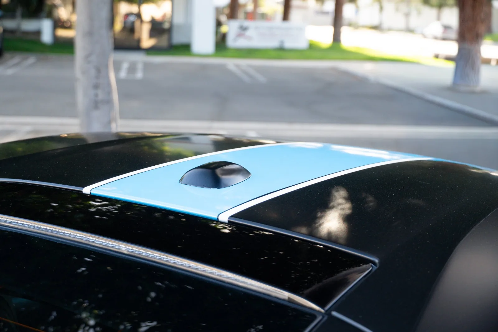 The light blue stripe running over the roof and rear glass of the satin black 812 Superfast