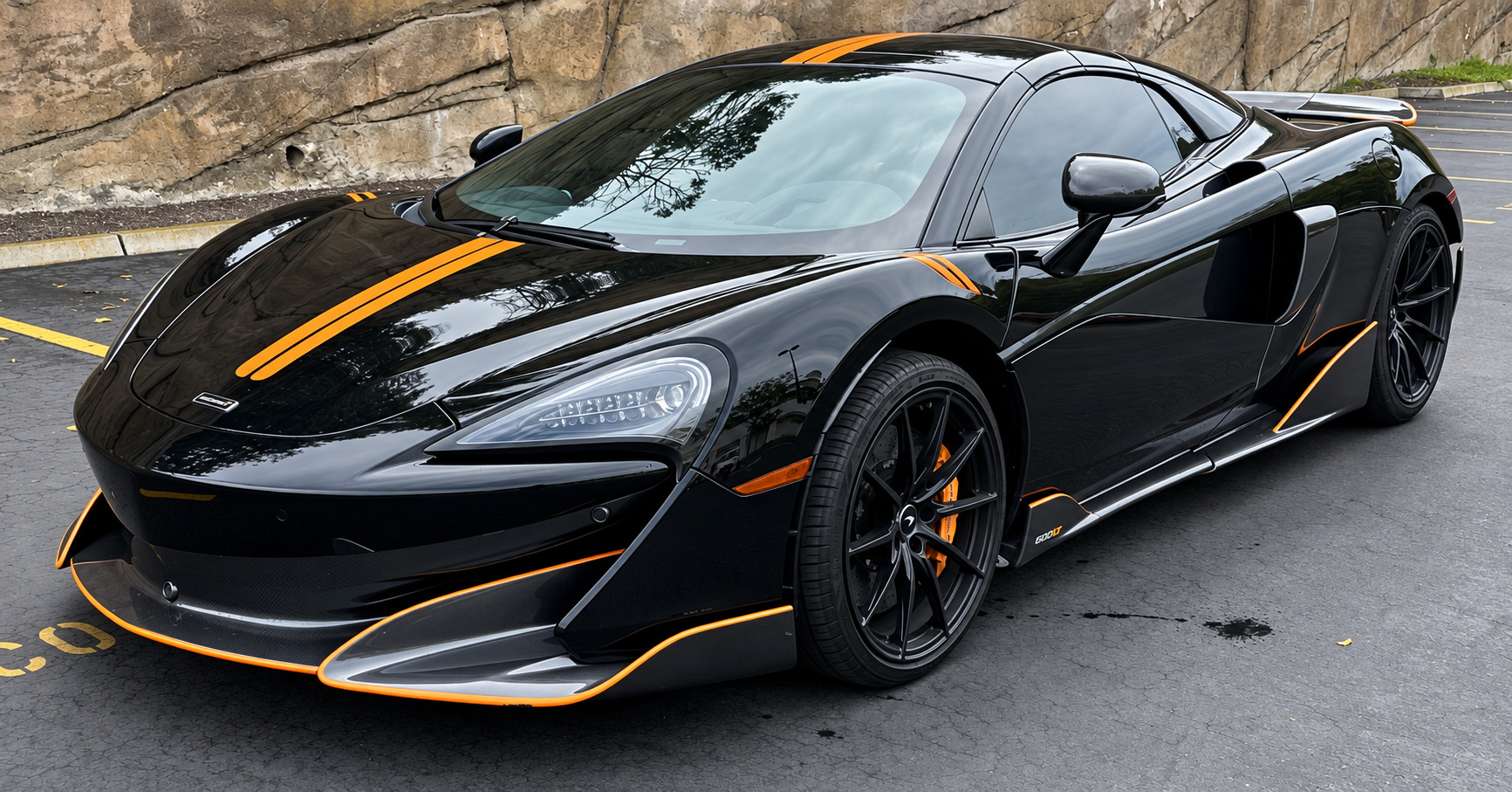 Black McLaren 600LT, front three-quarter view, a 592 hp twin-turbo V8 Spider to rent in Southern California