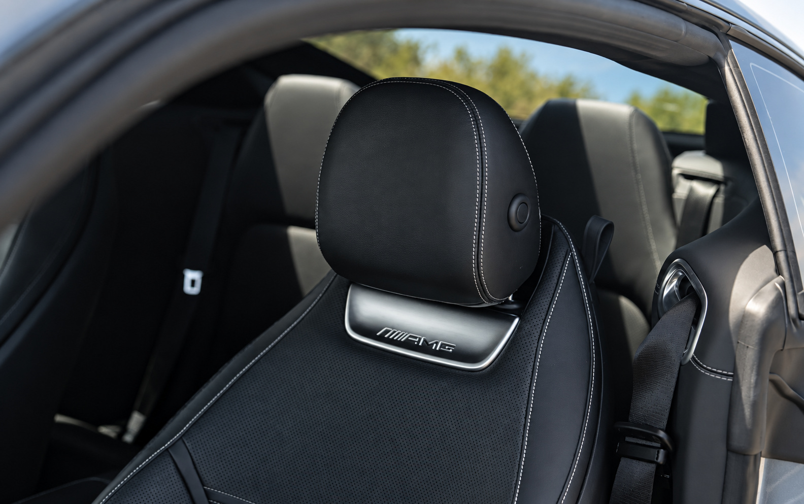 Black leather AMG sport seat in the Mercedes-Benz AMG GT 43 with the AMG badge stamped into the headrest