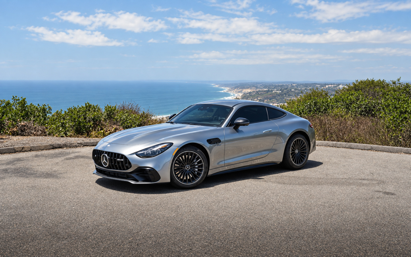 Hightech Silver Mercedes-Benz AMG GT 43 coupe, front three-quarter on a coastal overlook above the Pacific