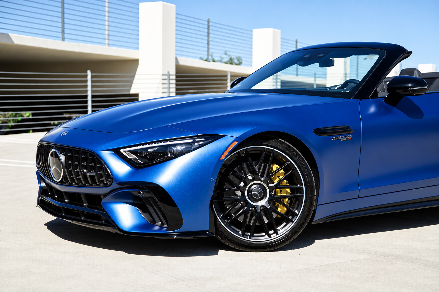 Blue Mercedes-Benz AMG SL, front three-quarter view, a 577 hp twin-turbo V8 roadster to rent in Southern California