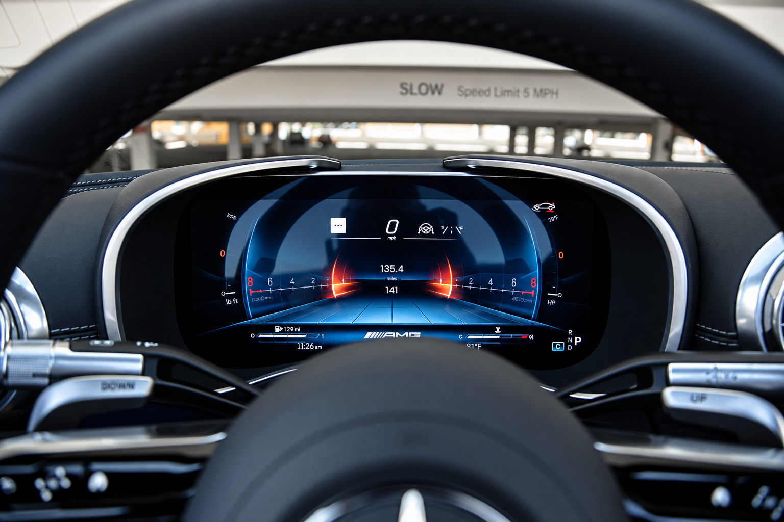 Digital instrument cluster of the Mercedes-Benz AMG SL rental seen through the AMG steering wheel