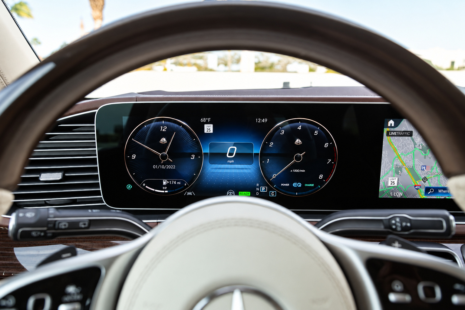 Digital instrument cluster of the Maybach GLS 600 seen through the cream-rimmed steering wheel
