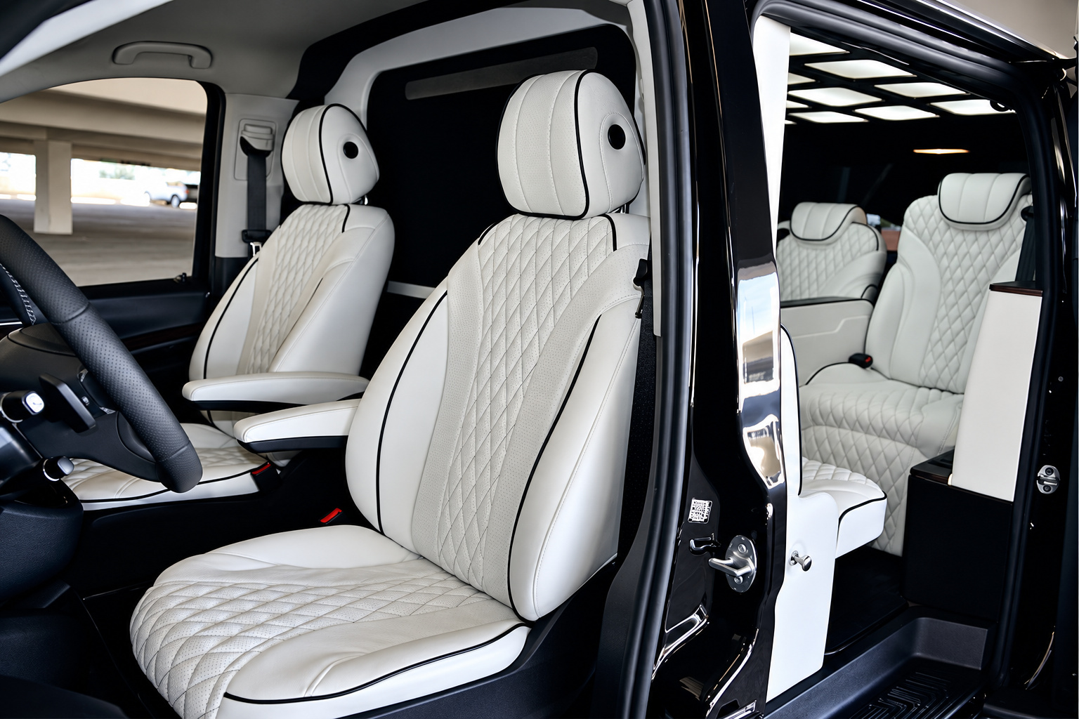 Front seats of the Mercedes-Benz Metris rental in white diamond-quilted leather, seen through the open door