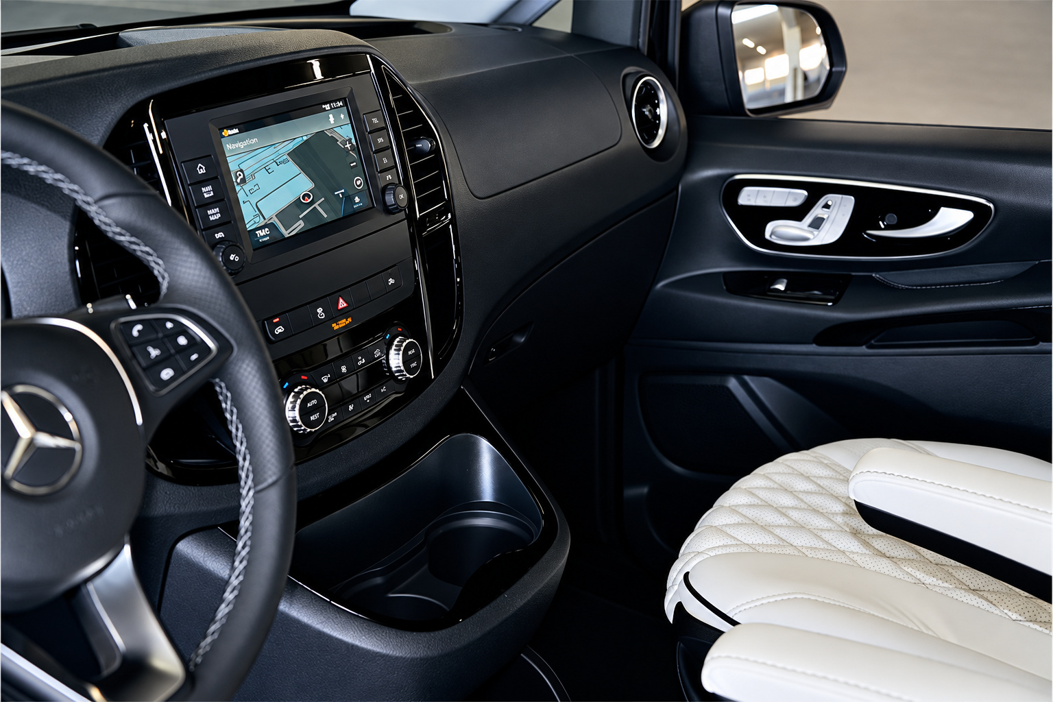Dash of the Mercedes-Benz Metris rental, steering wheel, centre screen and a white quilted seat
