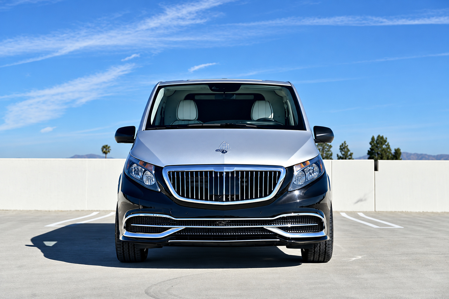 Head-on view of the two-tone Mercedes-Benz Metris rental, chrome vertical-bar grille and silver hood