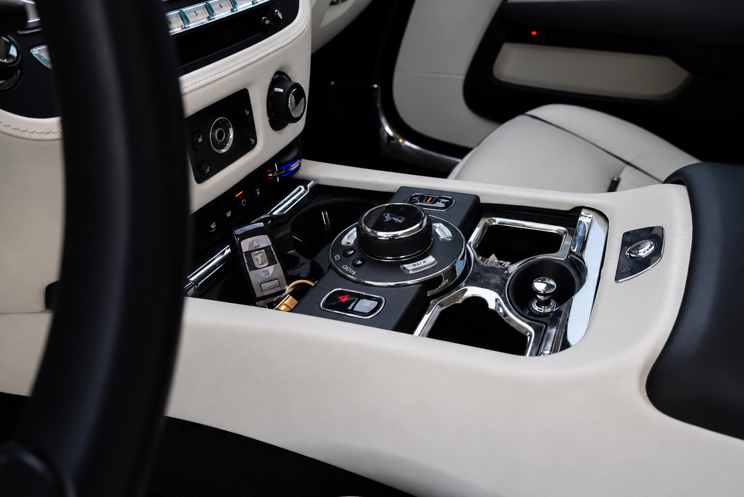 Center console of the Wraith with the rotary controller, ivory leather and the black dash
