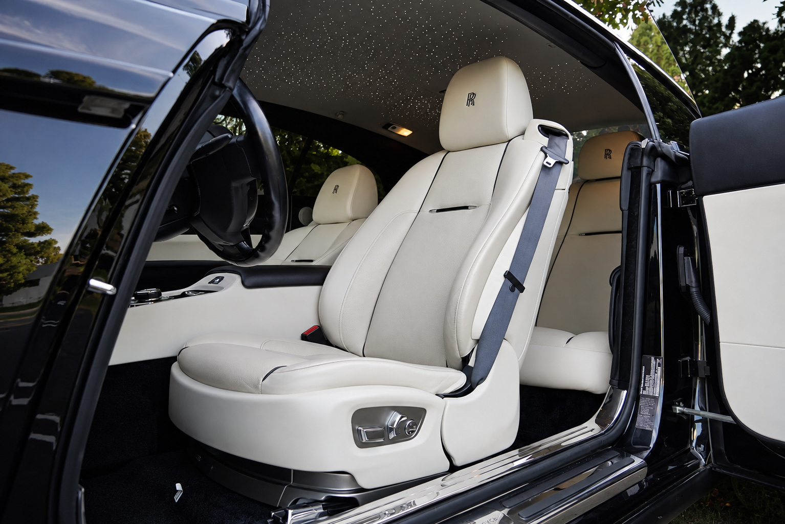 Ivory front seats of the Wraith with RR stitched into the headrests, seen through the open coach door