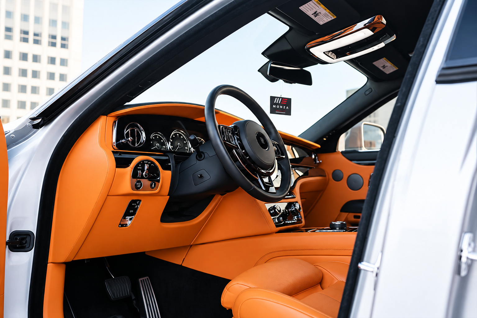 Driver's view of the Ghost cabin, orange leather seats and door panels with the black dash and wheel