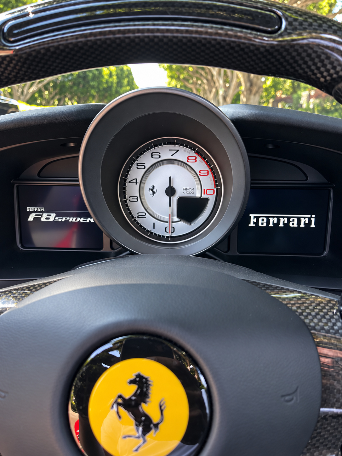 Carbon steering wheel of the F8 Spider with the yellow Cavallino and the central rev counter behind it