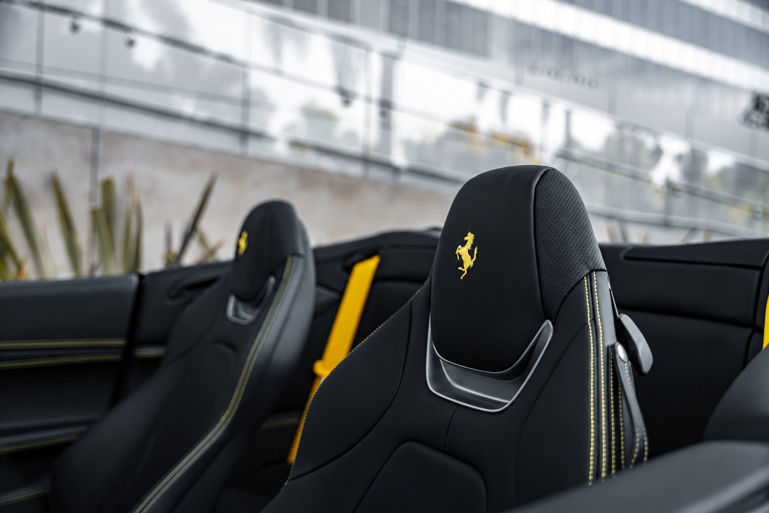 The 2 front headrests of the Portofino with a yellow Cavallino stitched into each and the yellow belts
