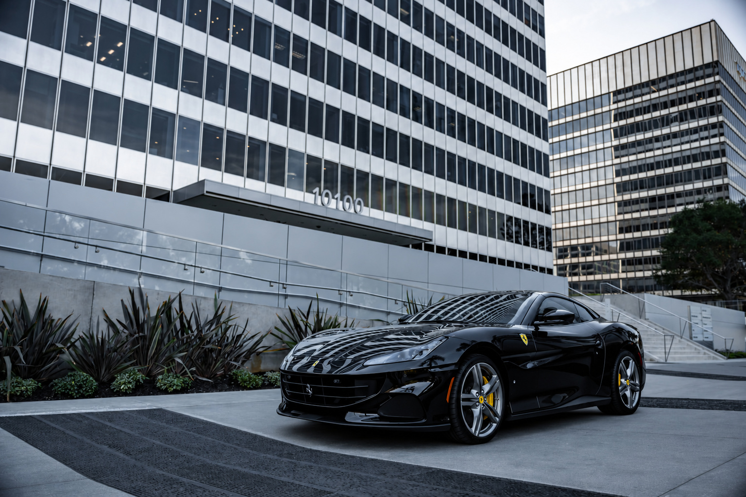 Front three-quarter of the black Portofino on the Century City plaza with the roof folded