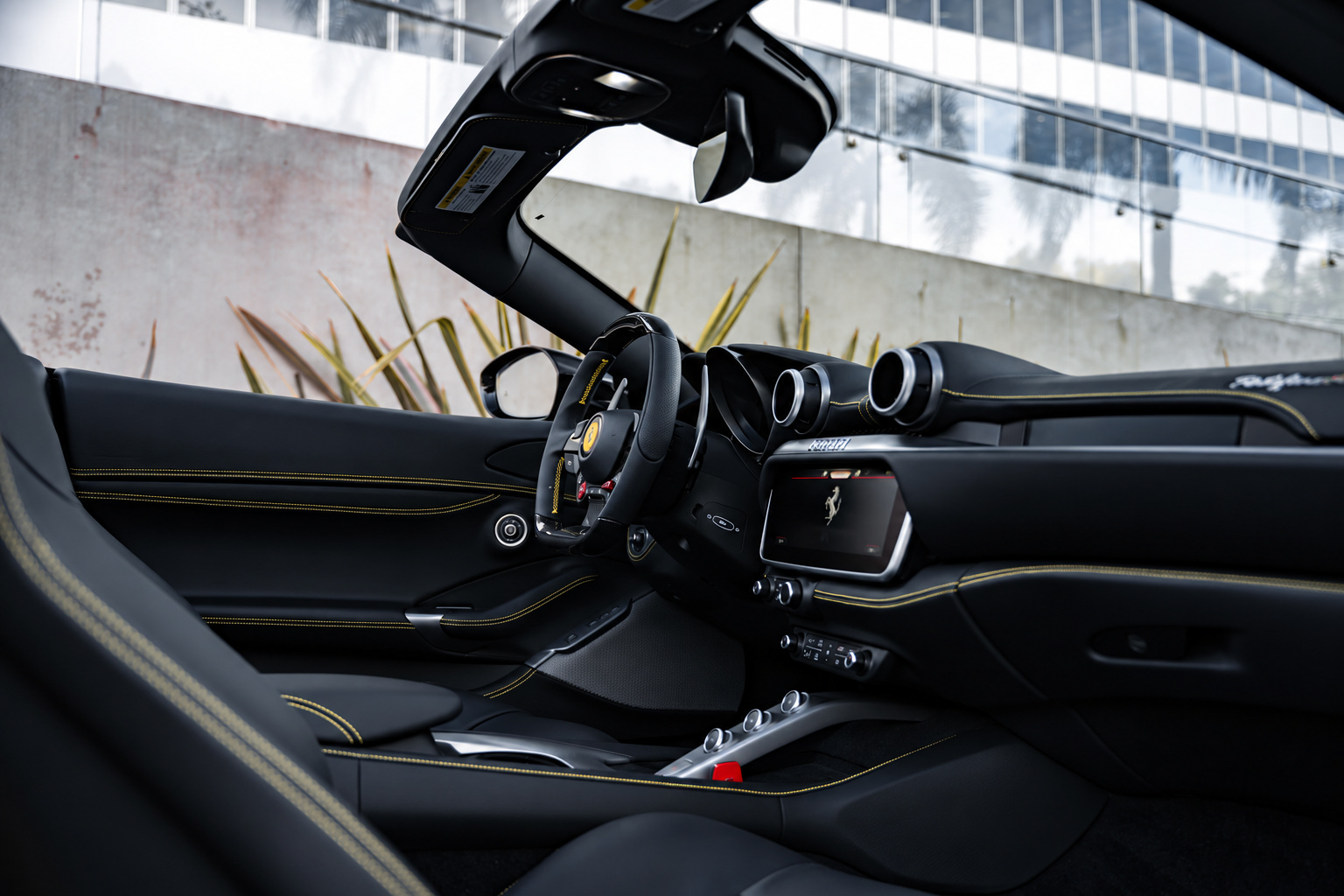 Looking across the open Portofino cabin from the driver's door, yellow stitching on the black leather
