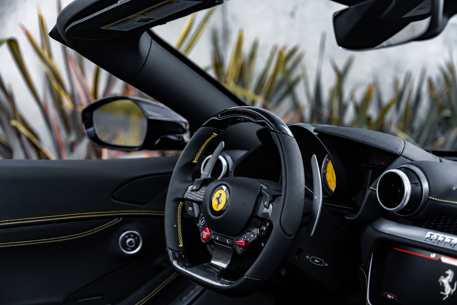 Portofino steering wheel with the yellow Cavallino, red manettino and start button, roof down
