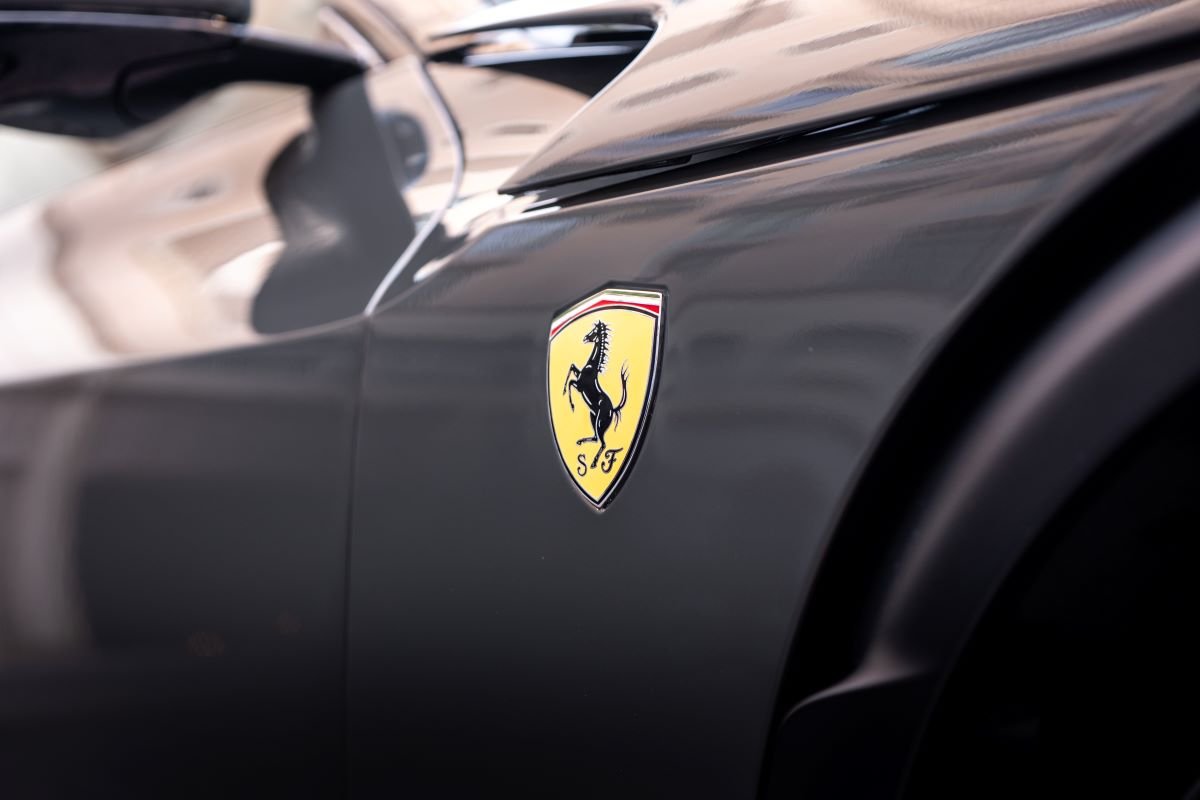 Scuderia shield on the dark grey front wing of the Ferrari Purosangue in close up