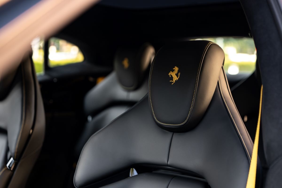 Rear headrest of the Purosangue with a yellow Cavallino stitched into the black leather