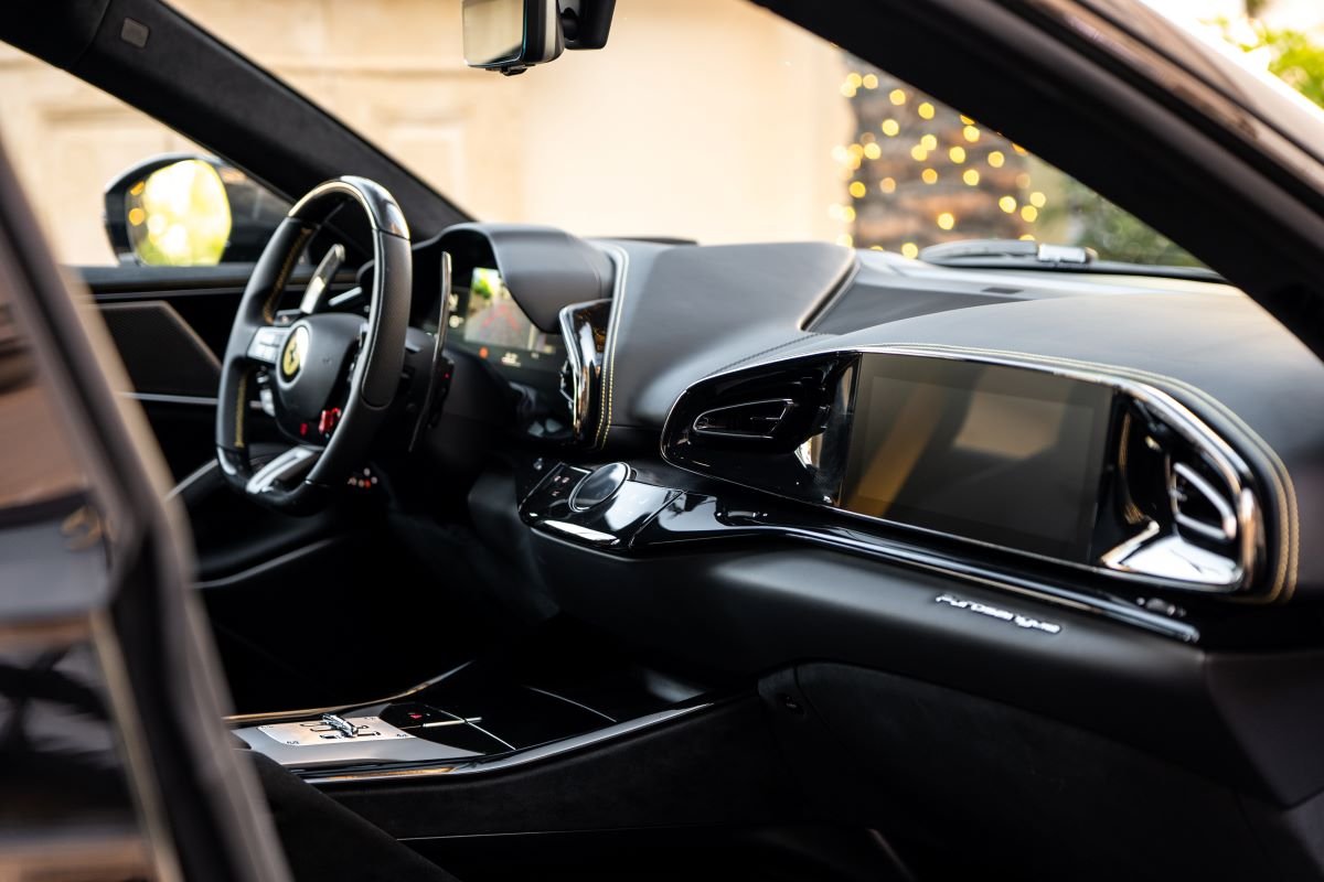 Passenger side of the Purosangue dash with the passenger display and the yellow-stitched black leather