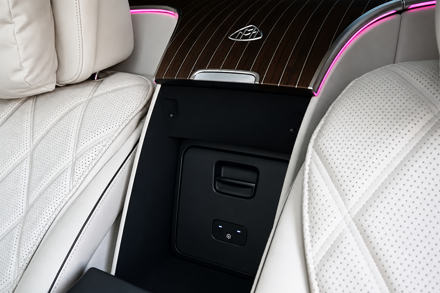 Diamond-quilted cream leather and the Maybach emblem in the rear door of the green S580