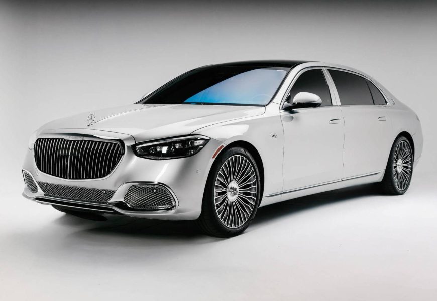 Pearl white Maybach S680 on chrome pinwheel wheels, front three-quarter studio view