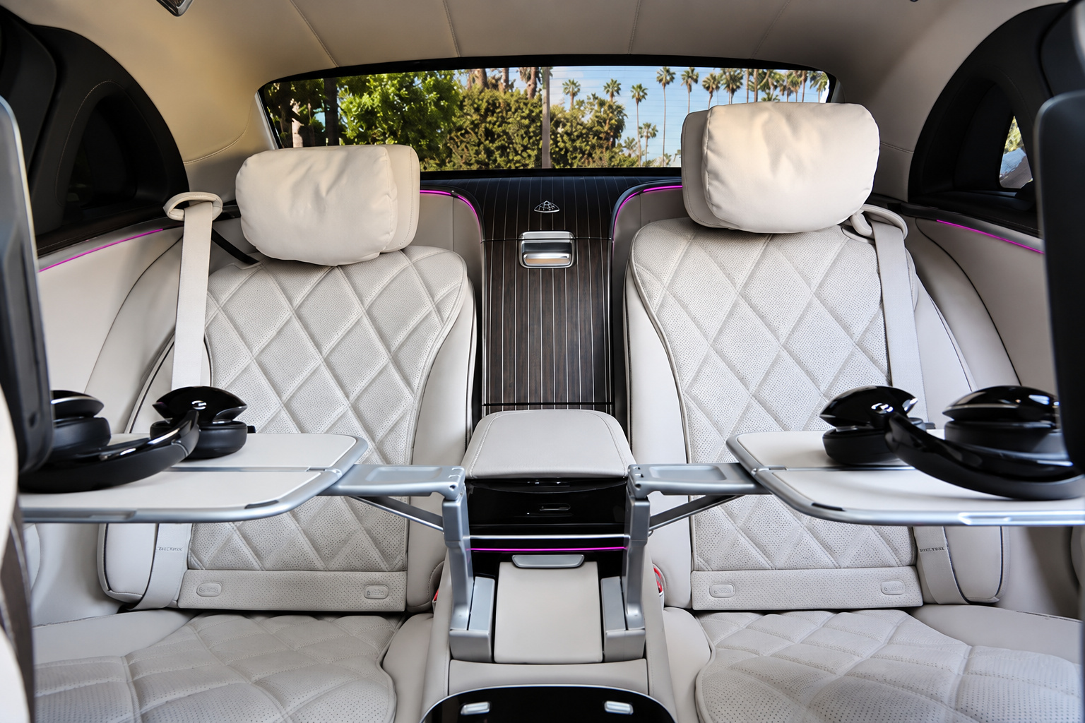 Both rear seats of the Maybach S580 with tables out, cupholders and cream quilted leather