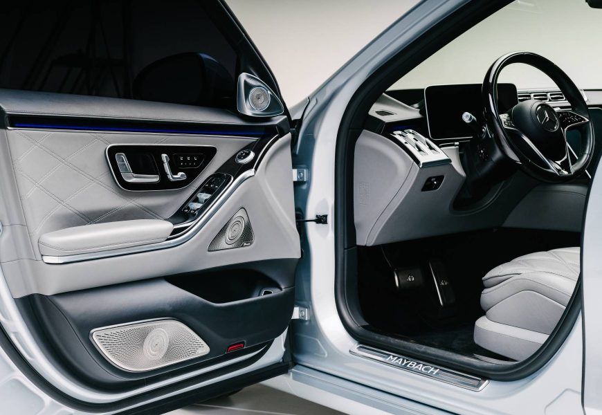 Open driver door of the white Maybach S680 showing the quilted door panel and Maybach sill plate
