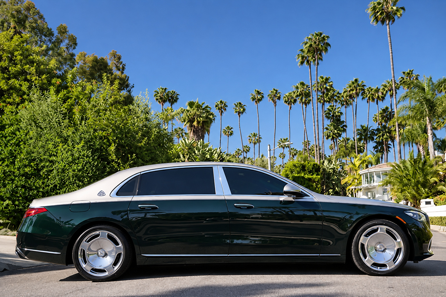 Side profile of the emerald green and silver Maybach S580 on chrome multi-spoke wheels in Beverly Hills