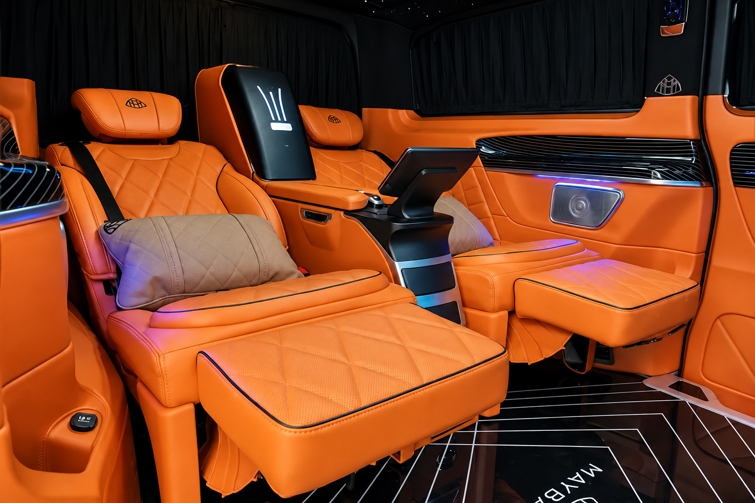 Captain chair of the Mercedes-Benz Sprinter rental reclined with the leg rest up and the orange cabin lit