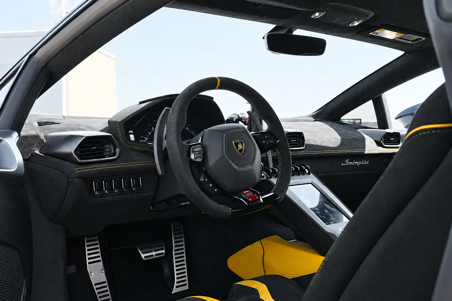 Driver's view inside the Huracan STO, alcantara wheel with yellow band, alcantara dash and yellow floor mats