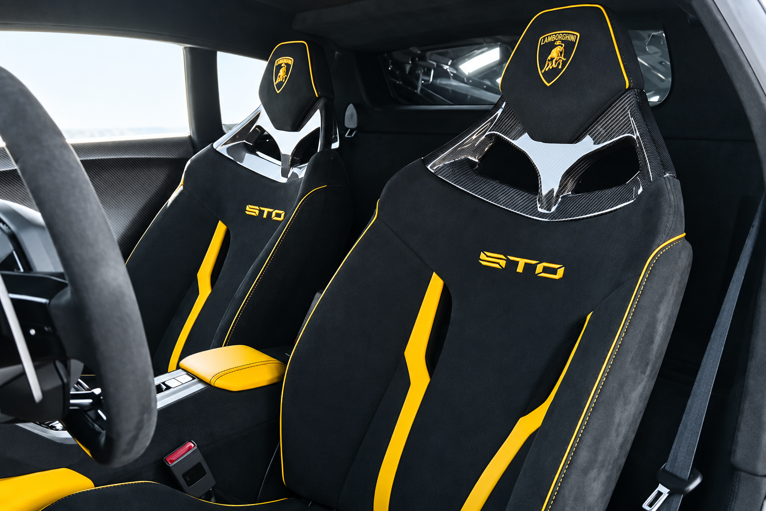 Black alcantara bucket seats in the Huracan STO with yellow stripes and STO stitched into the backrests