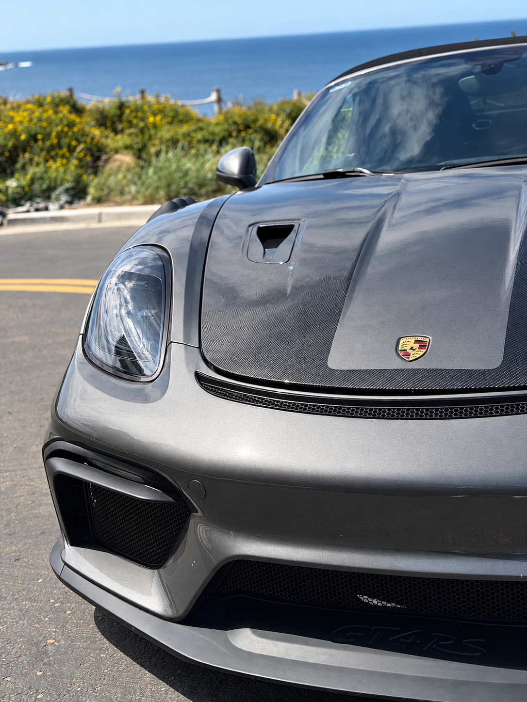 Close front view of the custom Boxster S showing the deep aero bumper, large intakes and the hood vent