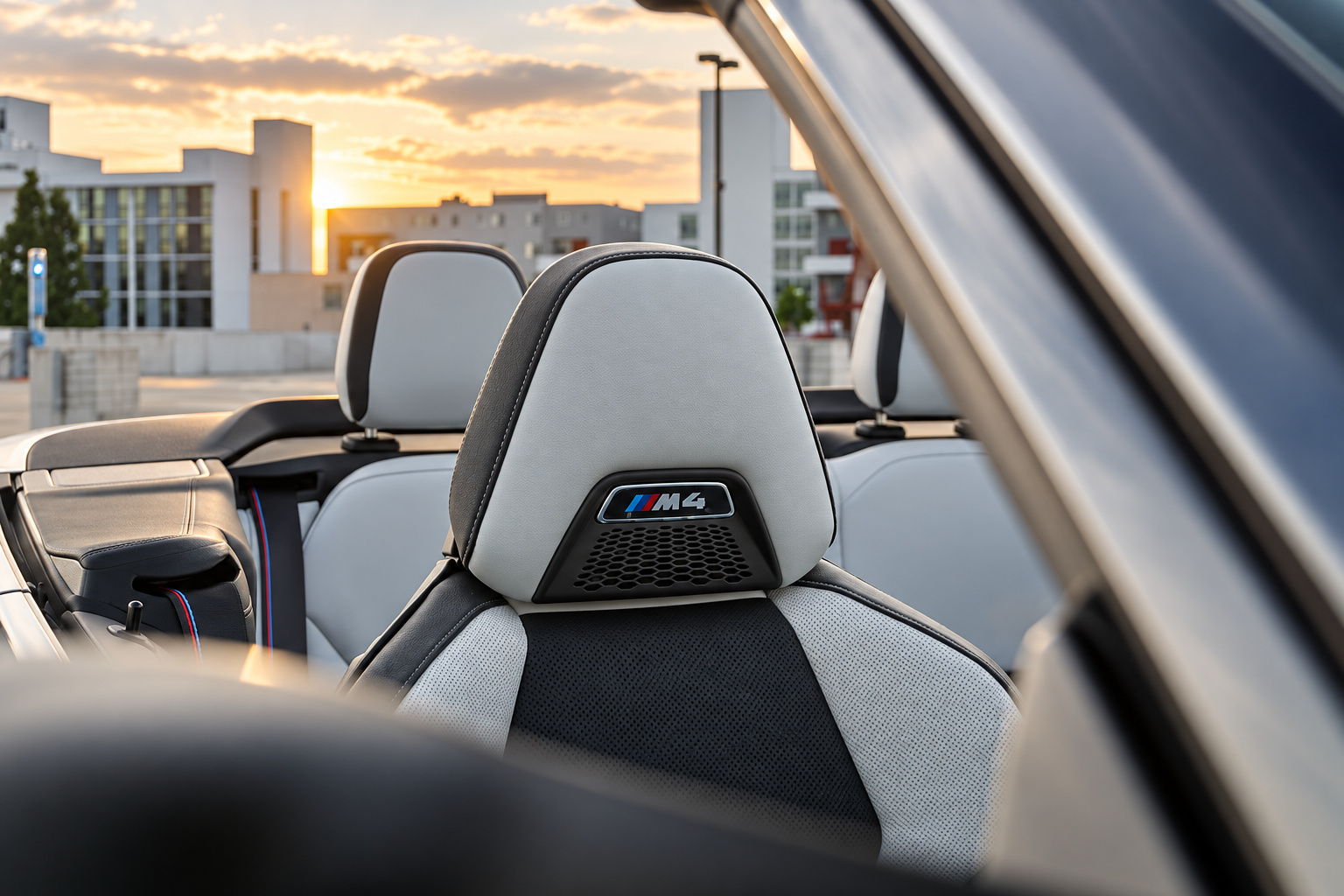 Ivory white M Sport seat headrests with the M4 badge stitched in, roof down, inside the M4 Competition Convertible