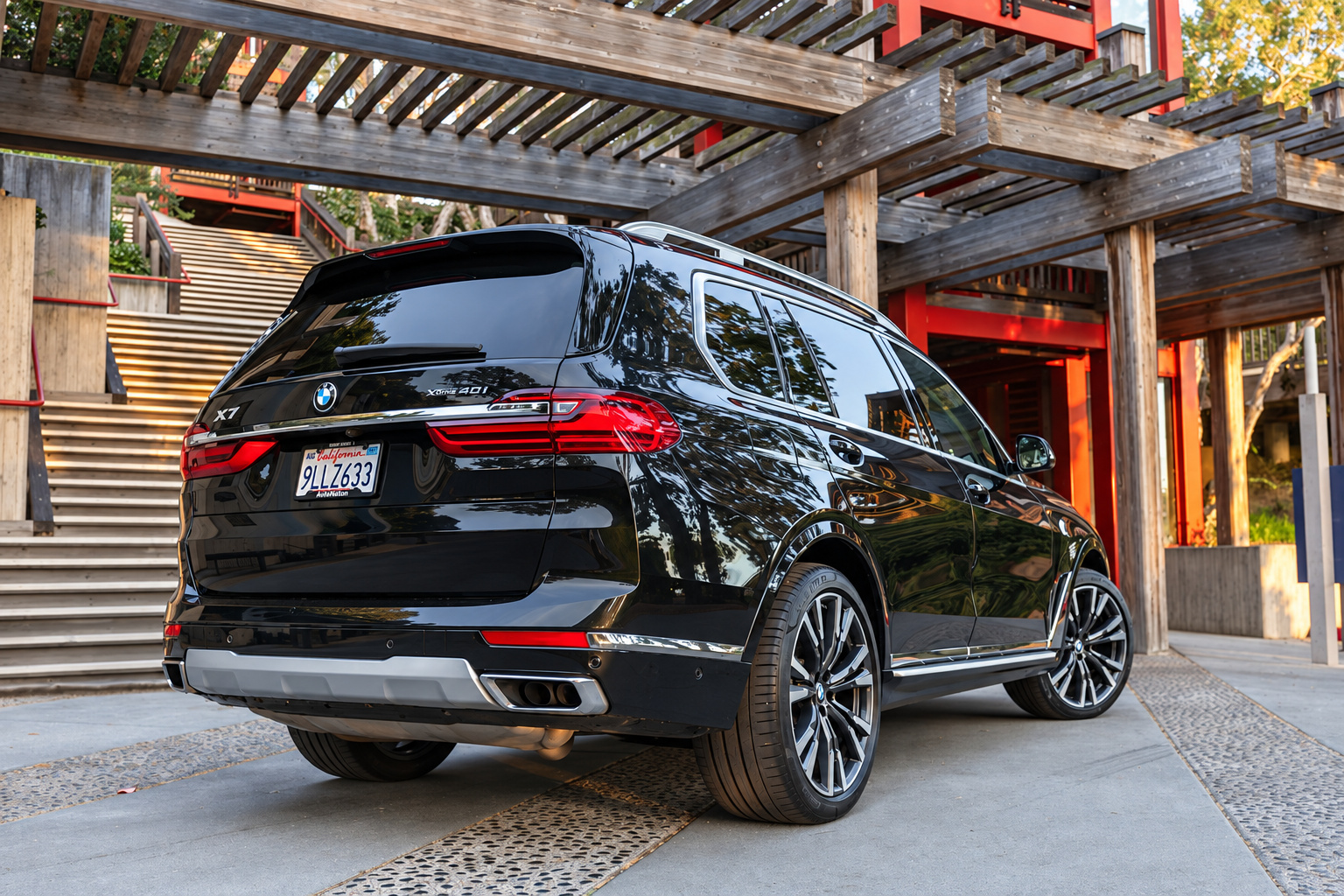 Black BMW X7, rear three-quarter view, a 335 hp inline-6 3-row SUV to rent in Southern California