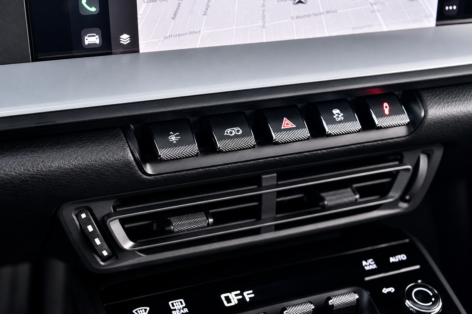 Centre console switches and air vents inside the black cabin of the Porsche 911 Carrera T