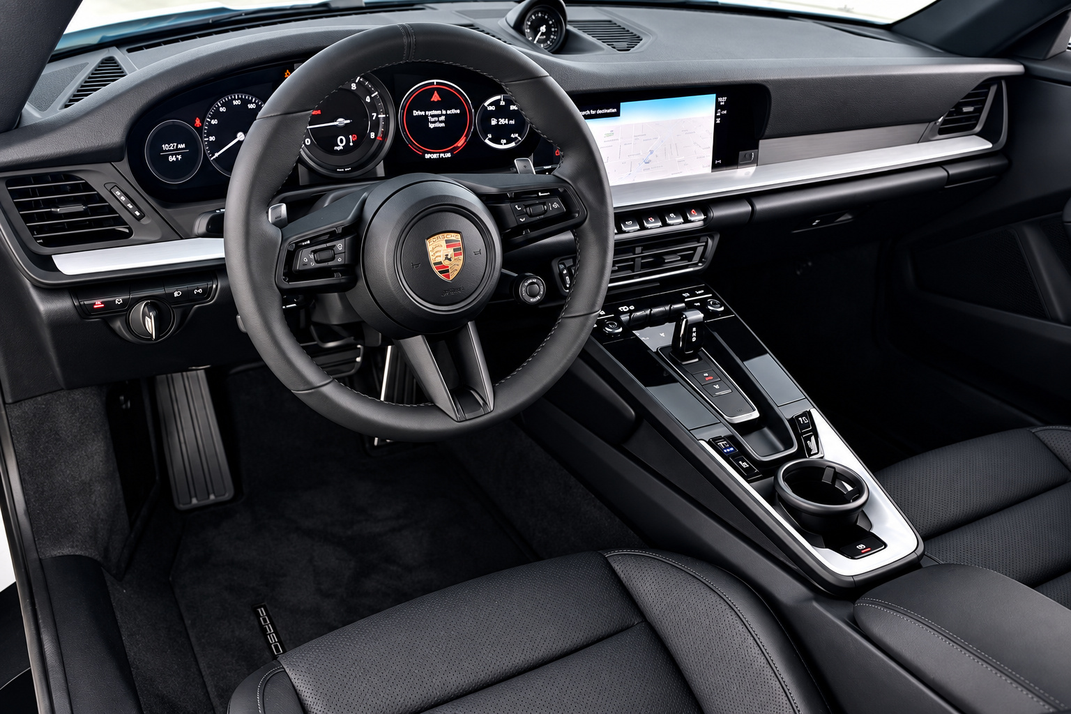 Driver view of the Porsche 911 Carrera T with the analogue tach, PDK toggle and black steering wheel