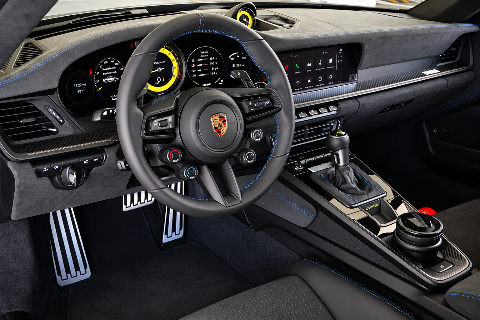 Steering wheel of the Porsche 911 GT3 RS with the yellow top marker, rotary dials and suede trim