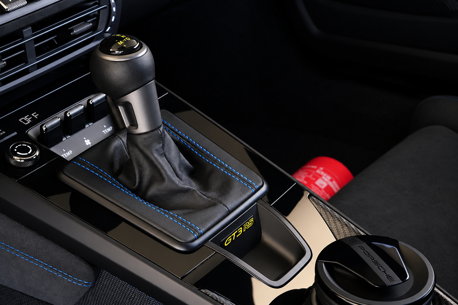 PDK shifter with blue stitching inside the Porsche 911 GT3 RS Weissach, fire extinguisher beside the console