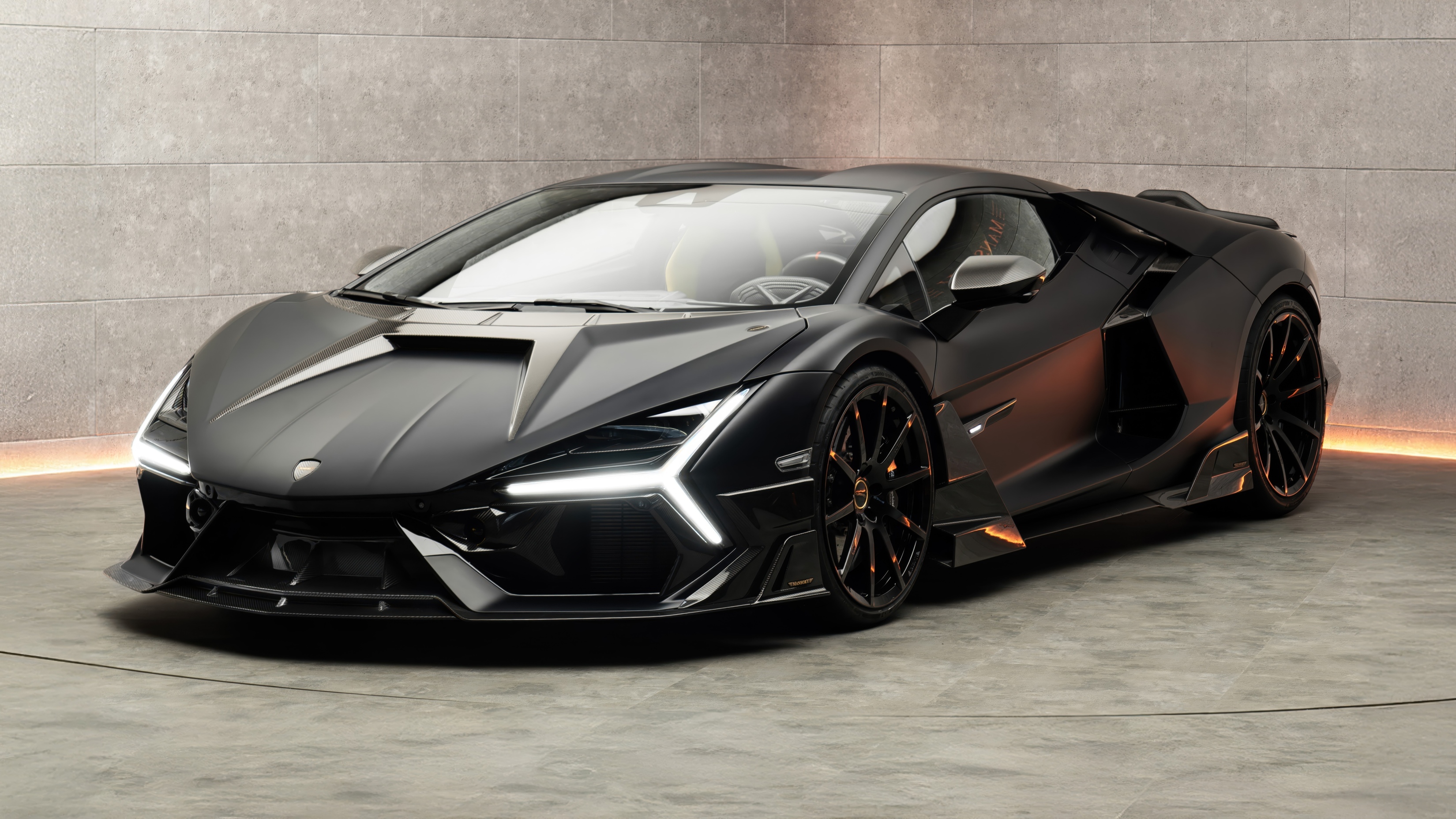 Black Lamborghini Revuelto in a stone showroom, exotic car rental in Southern California