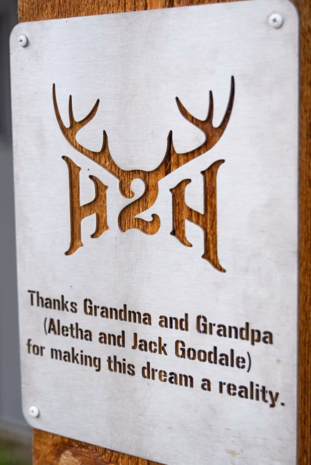 Metal plaque on wood thanking Grandma and Grandpa Aletha and Jack Goodale for making a dream a reality.