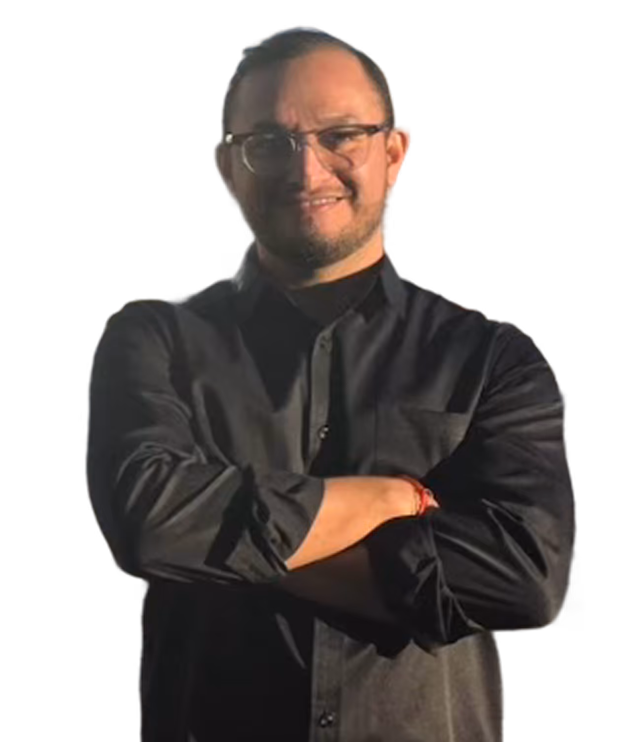 Le fondateur souriant portant une chemise noire, bras croisés, avec des lunettes et une barbe légère.